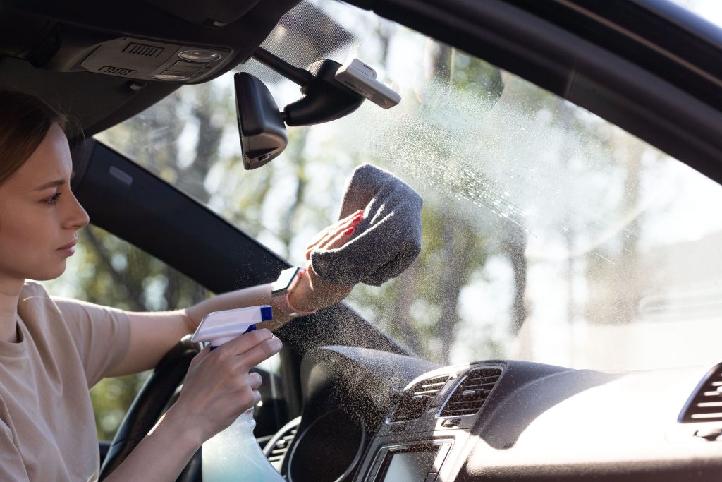 woman cleaning car windshield